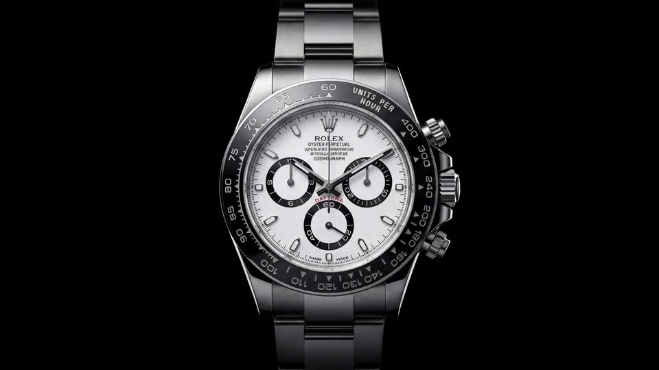A silver watch with a white dial against black, from the Rolex concept film